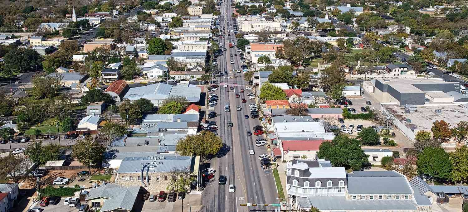 aerial view of a city street with cars and buildings at The Barons Park