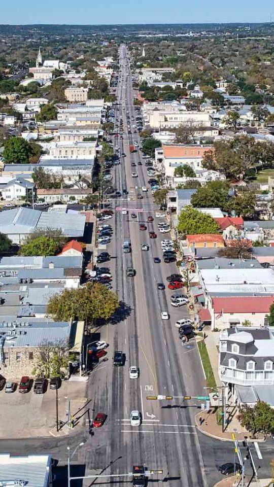 aerial view of a city street with cars and buildings at The Barons Park